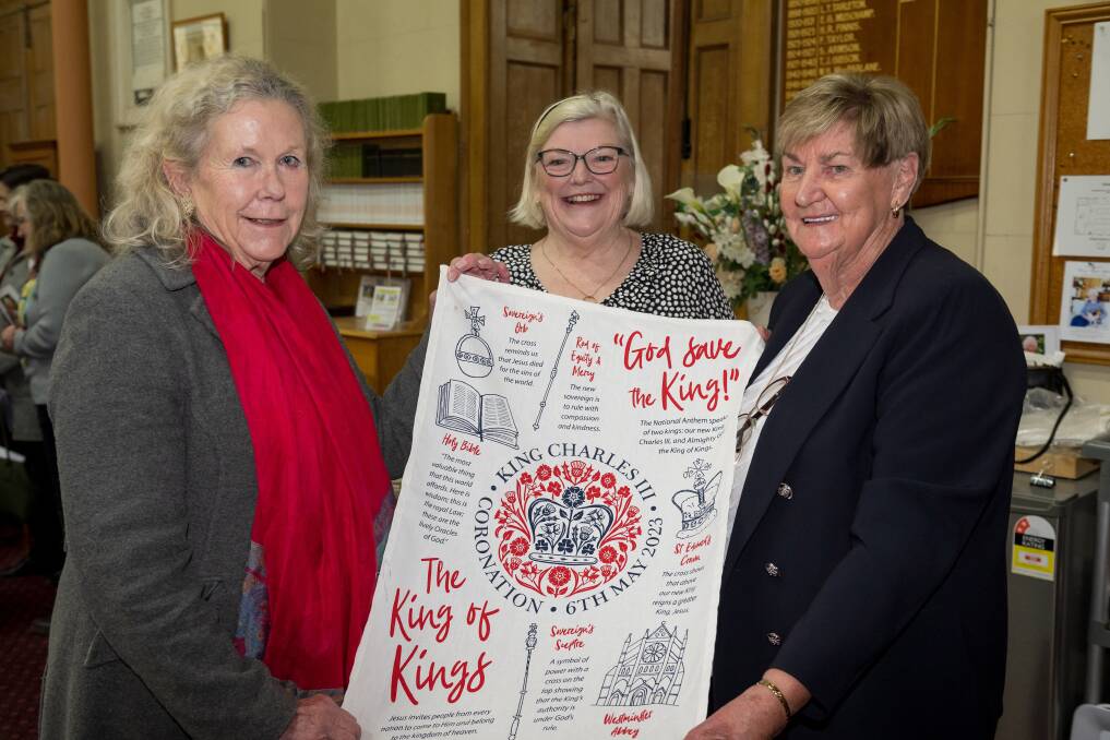 Suzie Terry, Diana Howard and Jenny Williams with a commemorative tea towel at Christ Church Anglican's coronation service in Longford. Picture by Phillip Biggs. 