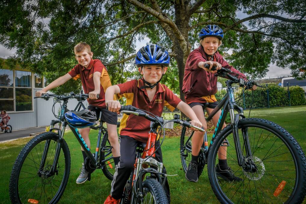 Waverley Primary School students Liam Partridge, 12, Braxton Thomson, 7, and Declan Williams, 12, with their new bikes. Picture by Craig George. 
