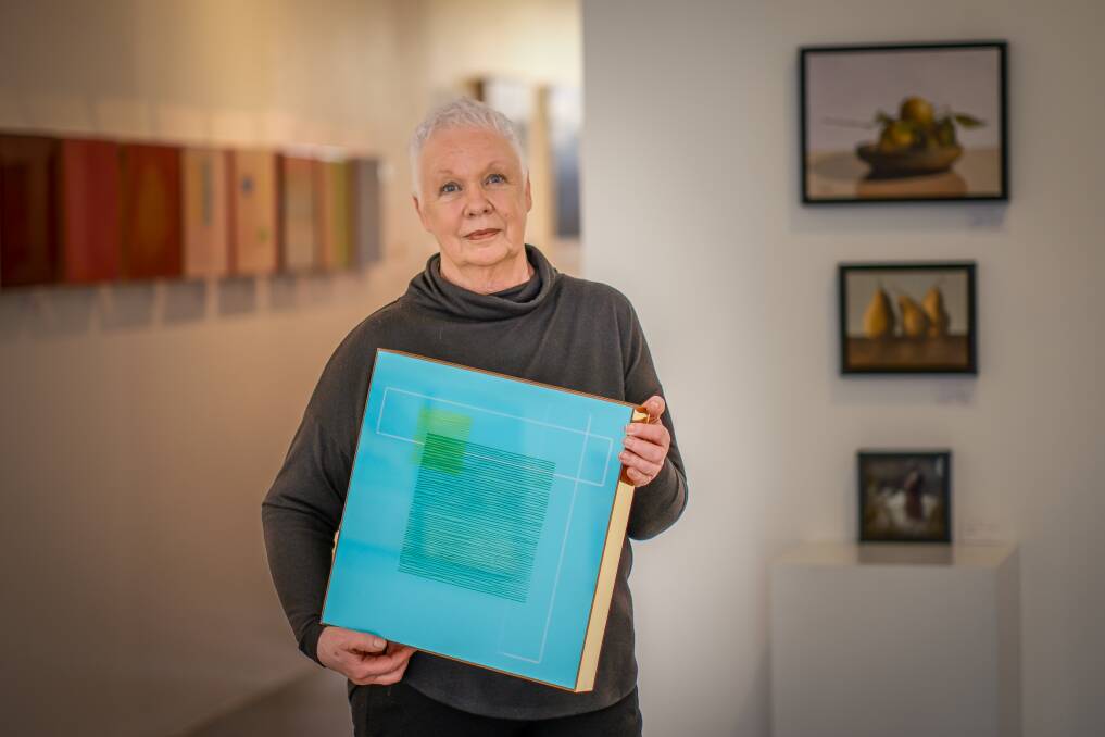 Dr Quinn holding her piece "Whimsy #13" from her solo show "Reflect" at Gallery Pejean. Picture by Craig George