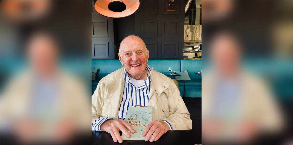 The late, great Australian abstract landscape painter John Olsen AO OBE with the book detailing his time in Campbell Town. Picture: Supplied