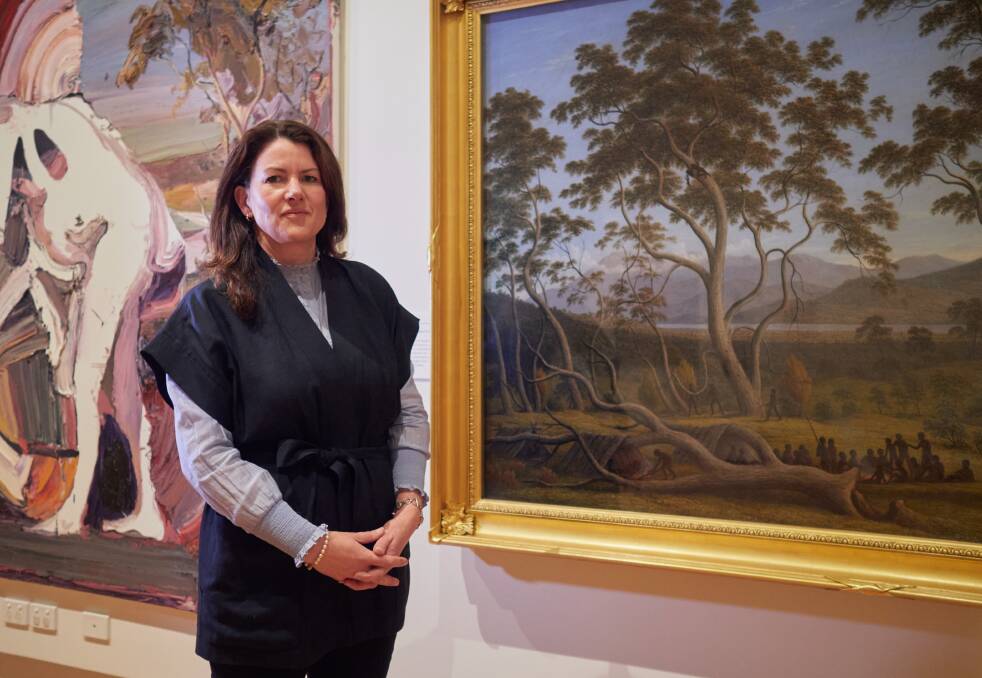 Glover Prize curator Megan Dick with John Glovers The last muster of the Aborigines at Risdon, part of QVMAGs collection within the Queen Victoria Art Gallery at Royal Park. Picture by Rod Thompson