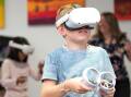 Flynn Grant age 10 tries out a VR headset at the Launceston Library. Picture by Philip Biggs