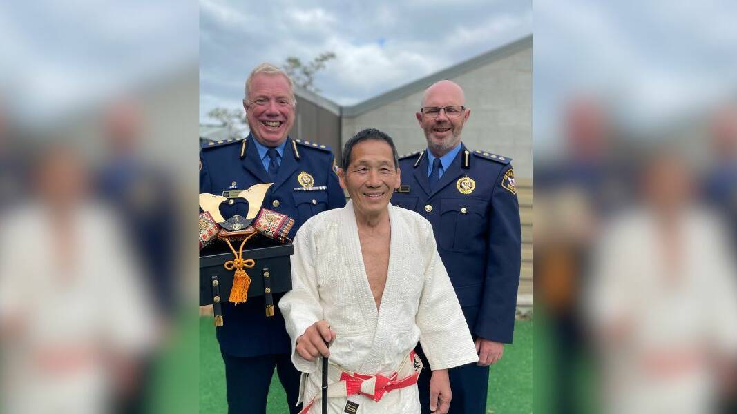 Taka Nakajima (centre) with Inspector Jon Cooper and Inspector Ian Lindsay with the Samurai helmet. Picture supplied
