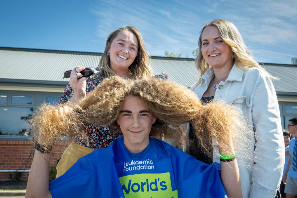 Kings Meadows High student Arthur Bishop grade 10 about to be shaved by hairdressers Ally Lovegrove and Tara Langerack for the World's Greatest Shave. Picture by Paul Scambler 