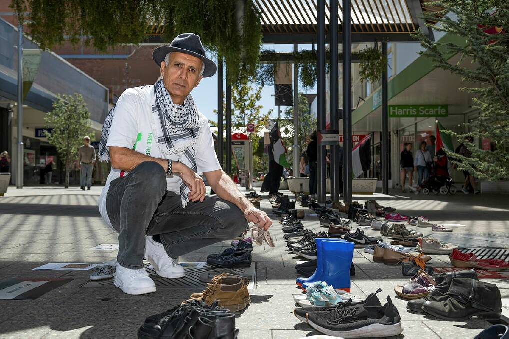 UTAS senior lecturer Adel Yousif's exhibition 'Shoes for Gaza' at Brisbane Mall. Picture by Phillip Biggs.