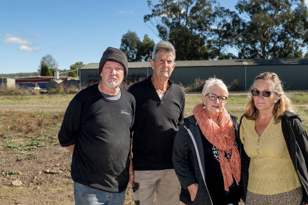 Nick Moore, Shane Farquhar, Annette Clark, and Liz Farquhar
are concerned about smoke from the nearby Tasmanian Honey Company, which is pictured behind them. Picture by Phillip Biggs
