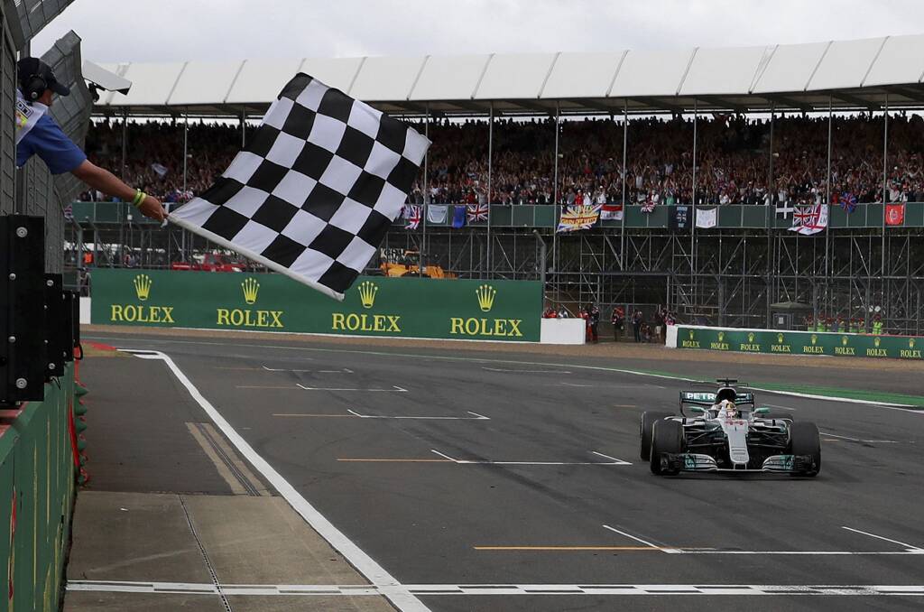 HOME TURF: Mercedes driver Lewis Hamilton of Britain crosses the finish line in the British Formula One Grand Prix. The race will remain at Silverstone for the next five years at least. Picture: AP Photo/Jason Cairnduff, Pool