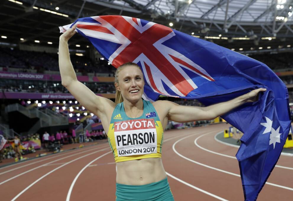 CHAMPION: Sally Pearson celebrates after winning the gold medal in the women's 100-metre hurdles final during the World Athletics Championships. Picture: AP