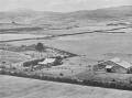 MAGNIFICENT MEN: An aerial pageant photo from February 1933 shows the grassed landing area at Western Junction and just-completed Tasmanian Aerial Services hangar. The original hangar is on the left. Picture: Tasmanian Aero Club archive, Launceston Library, LPIC117
