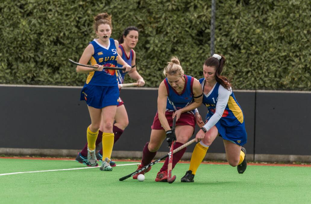 STICKING AT IT: Launceston Suns' Kira Budgeon crosses sticks with Robyn Loche from South Burnie. The Suns came away 4-0 winners. Picture: Paul Scambler. 