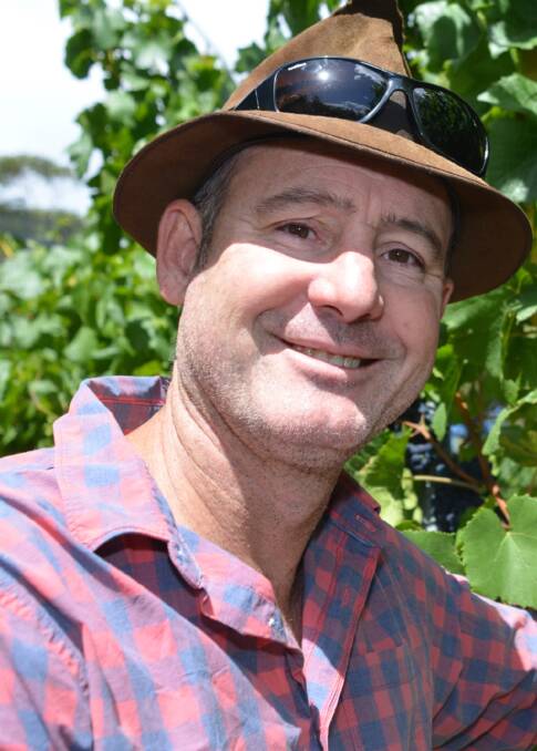 GROWING STRONG: Winemaker Jim with his Huon Pinot Noir. Picture: Mark Smith.
