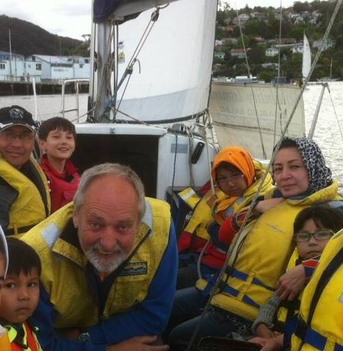 Tamar Yacht Club Vice Commodore Ken Gourlay giving Afghani families their first taste of sailing at the Discover Sailing Day.
