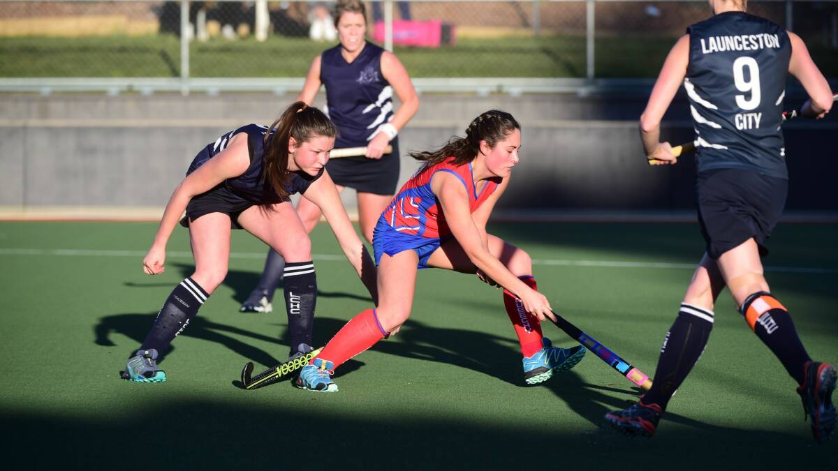 SURROUNDED: Queechy's Jess Curtis fights to find a way past Launceston City's Jenny Reterer and Sarah White. The Penguins proved too strong. Picture: Scott Gelston