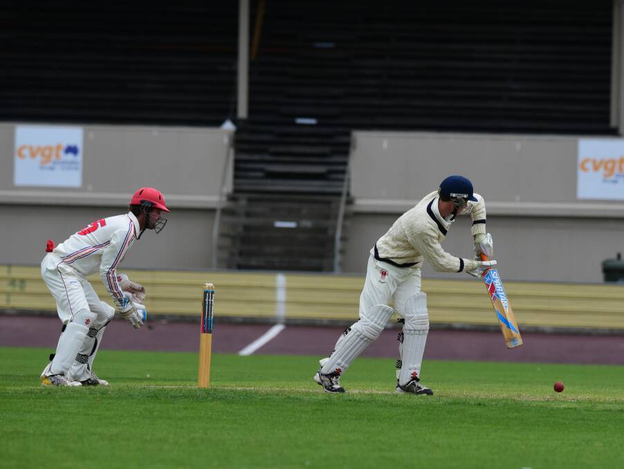 Devonport batsman Bruce Will takes a gentle swing with Latrobe wicket keeper Matt Clarke ready. 