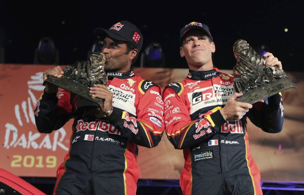Toyota's Nasser Al-Attiyah, of Qatar, left, and co-driver Matthieu Baumel, of France, celebrate the 2019 Dakar Rally. Picture: AP Photo/Martin Mejia