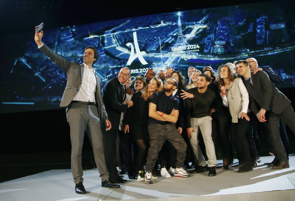 PARISIAN COOL: Paris 2024 Games' chief Tony Estanguet takes a selfie with a group including competitors in surfing, skateboarding, climbing and the newest addition to the Olympic stable, break dancing. Picture: AP Photo/Michel Euler