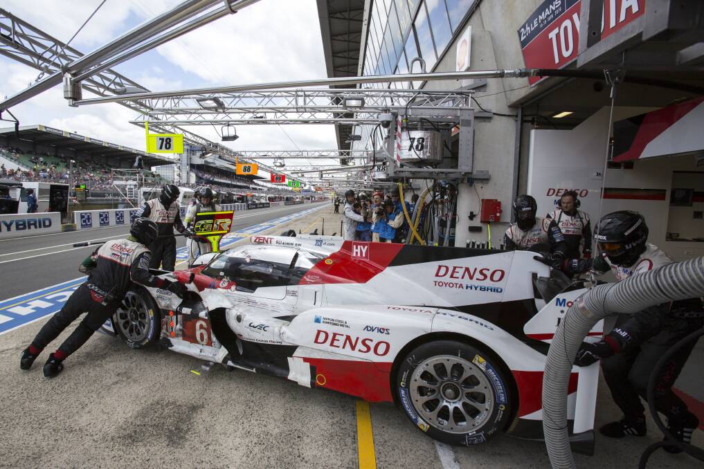 STALLED: Mechanics repair the Toyota TS050 hybrid driven by Mike Conway, Kamui Kobayashi and Stephane Sarrazin during 2016's 84th 24-hour Le Mans endurance race. Picture: AP Photo/Kamil Zihnioglu