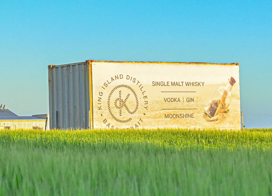 SIGN OF THINGS TO COME: A container sits amongst the barley, which will be made into a premium whisky at a new distillery being set up on King Island to supply the global market with top of the line brands. Picture: Supplied