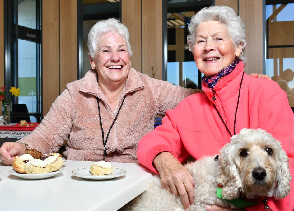 COMMUNITY FRIENDLY: Volunteer Wendy Nash and Wendy Onley of Ulverstone with Delta Dog Harry Fletcher, enjoy morning tea at the Central Coast Council's Connect Café in Ulverstone, a dementia-friendly place. Picture: Brodie Weeding
