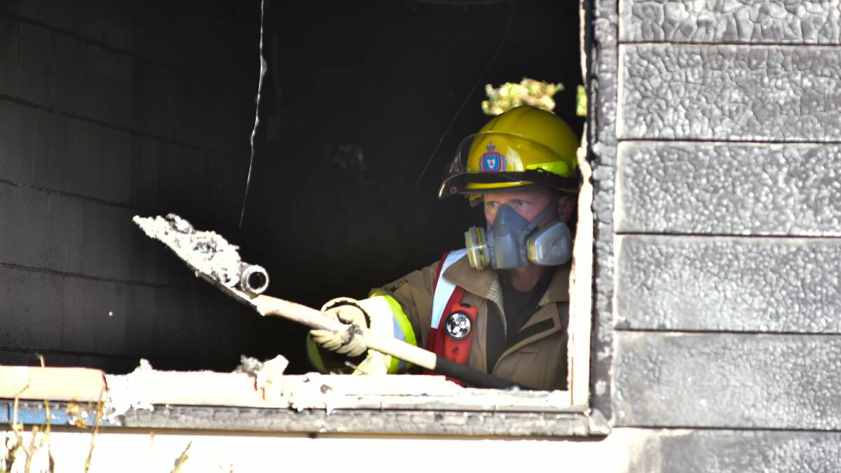 TFS at the New Street unit where a fire caused $180,000 damage. Picture: Neil Richardson.