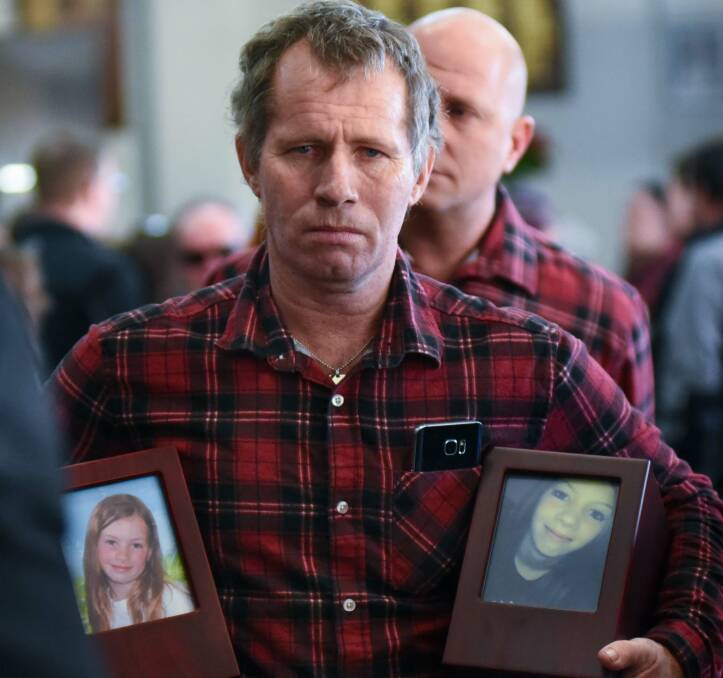DEVASTATED: Clifford Brewer carries the ashes of his two daughters, Ruby and Shanzel, at a memorial service for the girls in Lilydale. Picture: Neil Richardson.