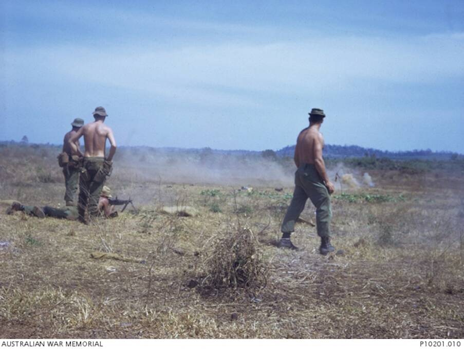 BELOW: Platoon Sergeant Robert James "Boof" Millwood (right) with fellow soldiers at the Nui Dat base firing range in Vietnam. Picture: The Australian War Memorial