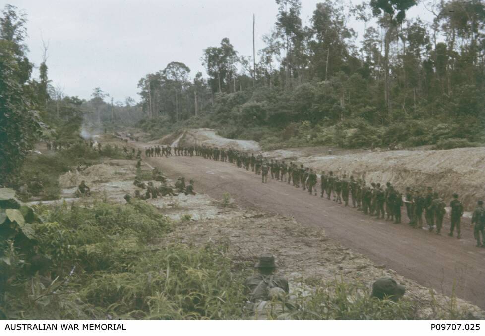 PATROL: Members of the 2nd Battalion, The Royal Australian Regiment, march along a road during Exercise Charity Angel in Malaya. Picture: Supplied by The Australian War Memorial