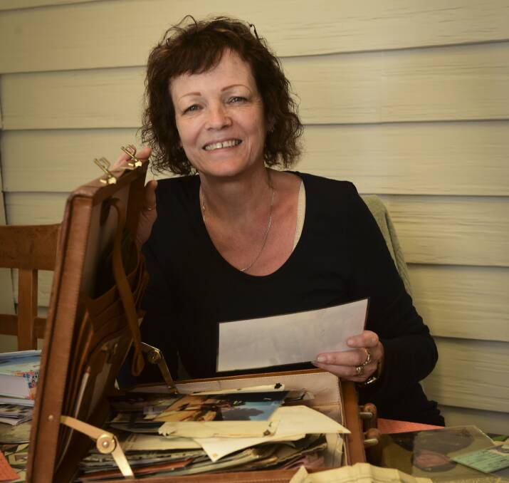 MEMORY LANE: Felicity O'Neill looks through old photos, newspaper clippings and letters belonging to her late husband Terry Tangney. Picture: Paul Scambler