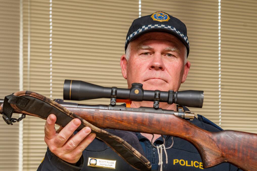 GUN CRACKDOWN: Inspector Scott Flude holding a firearm seized during a search in Launceston. Pictures: Phillip Biggs