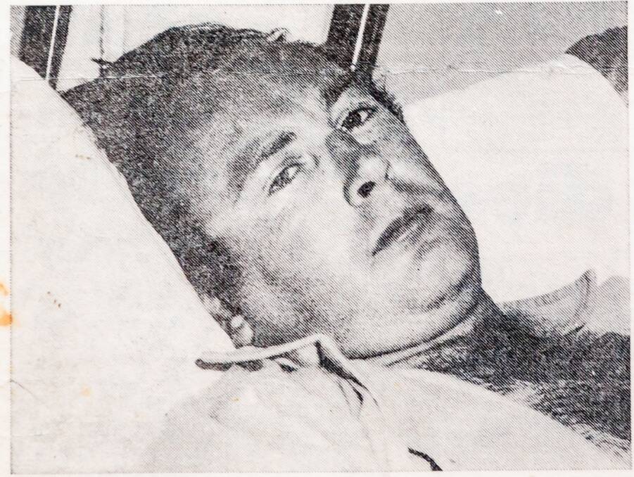Doug Brooks in a hospital bed after surviving a boating incident which killed three of his workmates.
