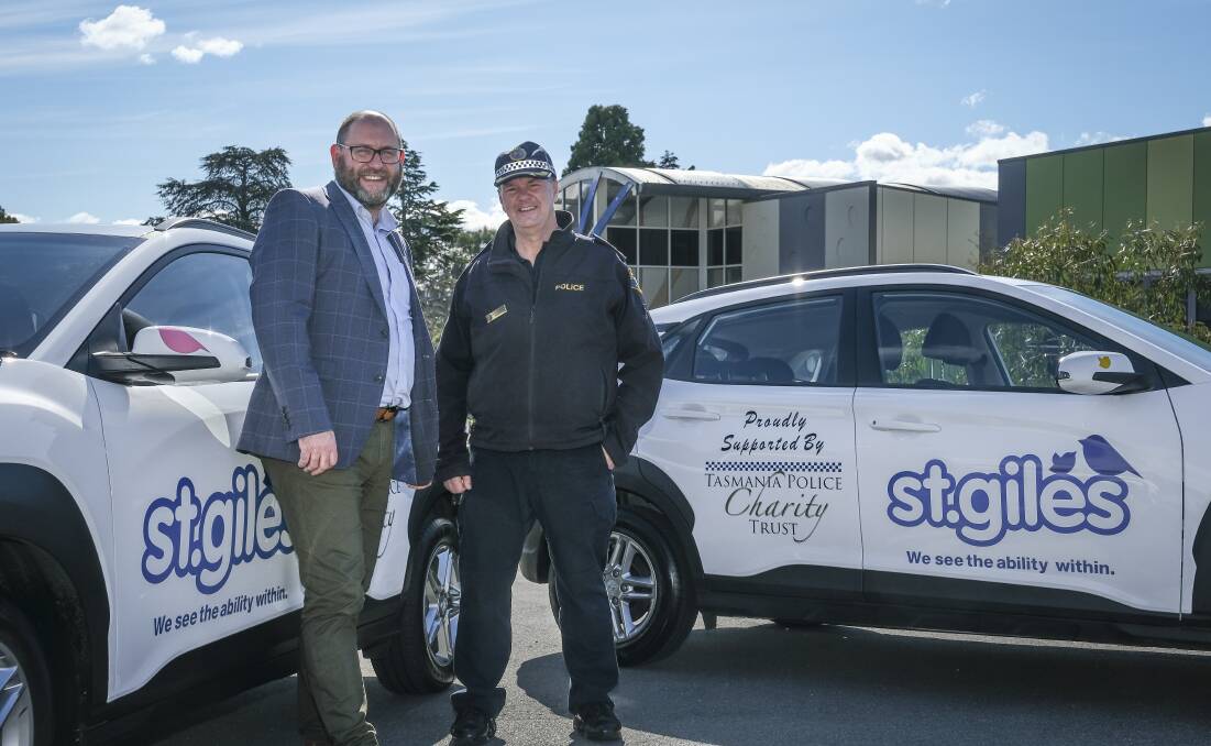 GIVING BACK: St.Giles chief executive Andrew Billing with Inspector Michael Johnson and the two new cars donated through the Tasmania Police Charity Trust. Picture: Craig George