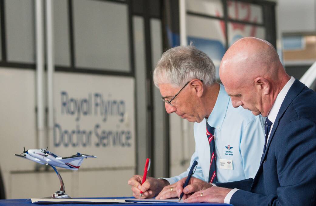 Royal Flying Doctor Service's Malcolm White signing a Memorandum of Understanding with Premier Peter Gutwein on Thursday. Picture: Phillip Biggs