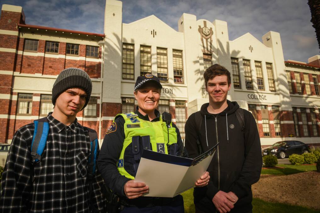 INFORMATION SESSION: Lachlan Souter and Reegan Coates talk with Constable Tarnya Frost ahead of the Tasmania Police public recruiting session at Launceston College on Wednesday night. Picture: Paul Scambler