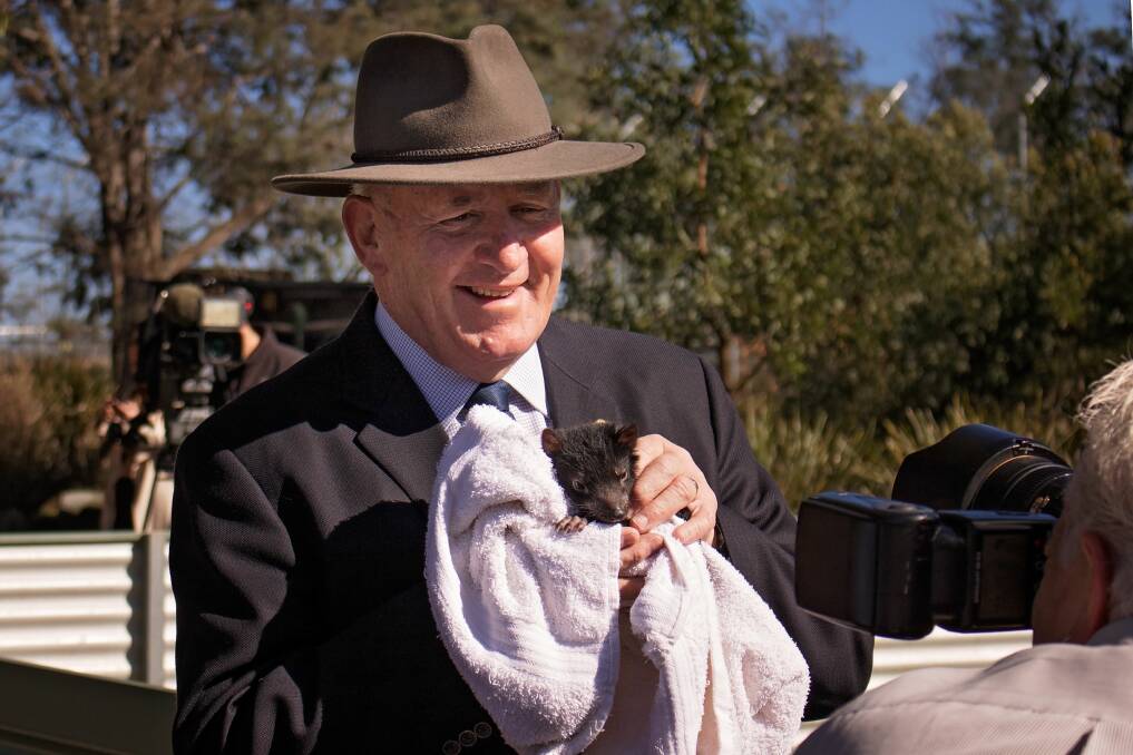 Governor-General Sir Peter Cosgrove with a baby devil at Tasmania Zoo on Wednesday. Picture: Fraser Laidlaw