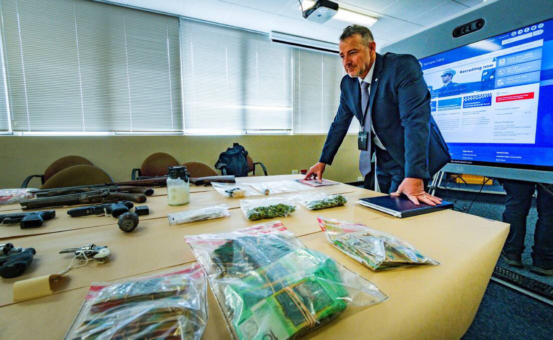 Detective Inspector Craig Fox with some of the items seized during searches. Pictures: Phillip Biggs