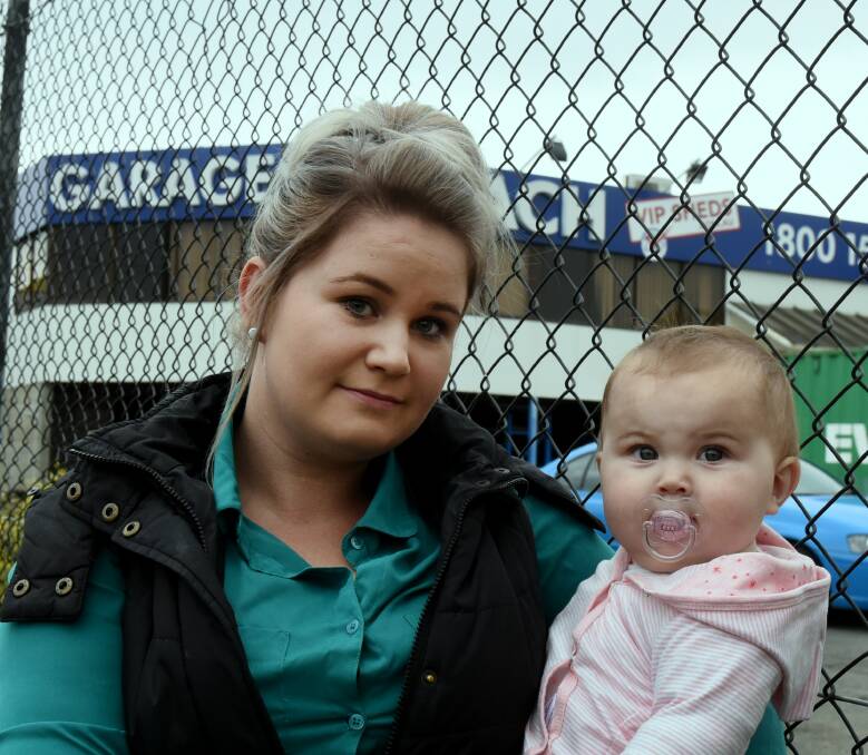 FRUSTRATED: Erin Gray, of Legana, holds her nine-month-old daughter Marlie outside of Sidach Sheds in Launceston. Photo: Neil Richardson. 