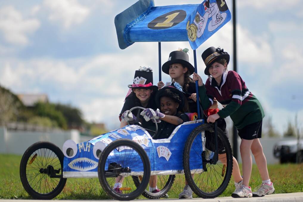 RACING: Launceston Christian School grade 5 pupils and billy cart racers Sharon Gbasie in the driver's seat, Madeleine Morgan, Ella Steyne and Faith Ranson get ready to race. Picture: Phillip Biggs