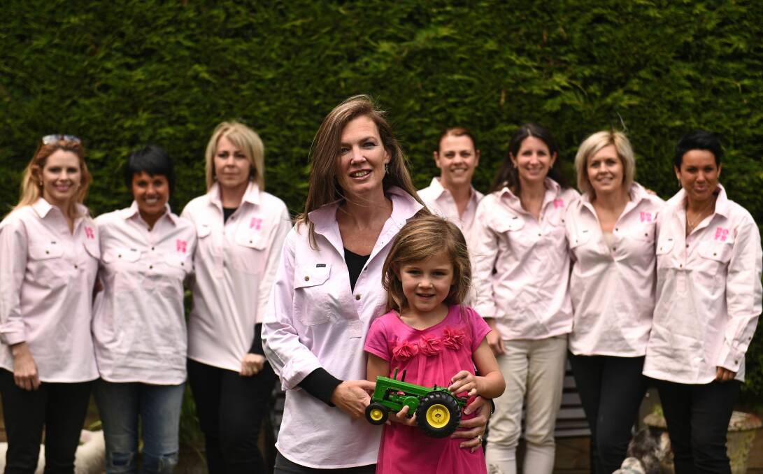 RAISING HOPE: Newstead breast cancer survivor Nicole Darcey, her daughter, Matilda, 5, and some members of the Breasts Out For Research committee. Picture: Scott Gelston