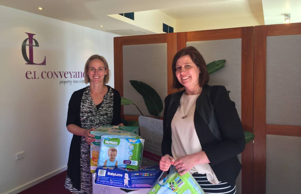GOOD CAUSE: El Conveyancing director Erin Sims and Storybook Communications founder and marketing consultant Kate Bucknell at the nappy drop-off point. 
