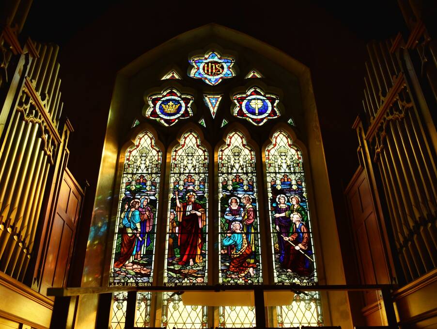 GLASS ART: Giant organ pipes flank the church's impressive stained glass windows. The pipe organ was dedicated in 1933.