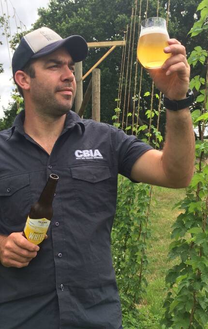 CRISP: Van Dieman Brewing director Will Tatchell admires a White Hills White Ale among the hops outside his brewery. 