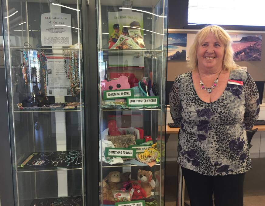 COMMUNITY: Scottsdale LINC customer service officer Sharon Sachse stands next to the jewellery creations and gifts provided for charity. 