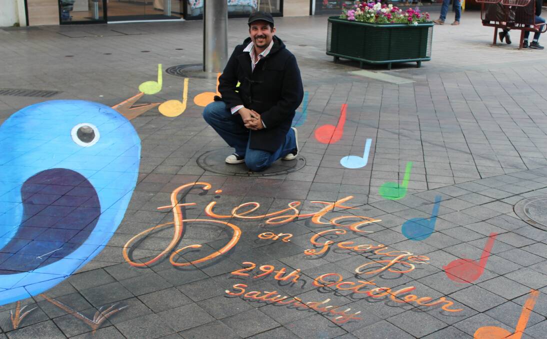 PARTY TIME: Sydney chalk artist Anton Pulvirenti's drawing is positioned in the centre of Brisbane Street Mall. 