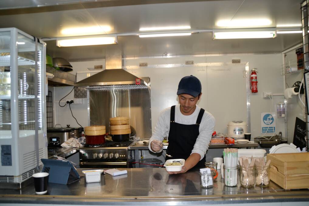 FRESH AND TASTY: Hide Nakano of the Smallgrain food truck puts the finishing touches on some steamed pork dumplings. Picture: Kasey Wilkins