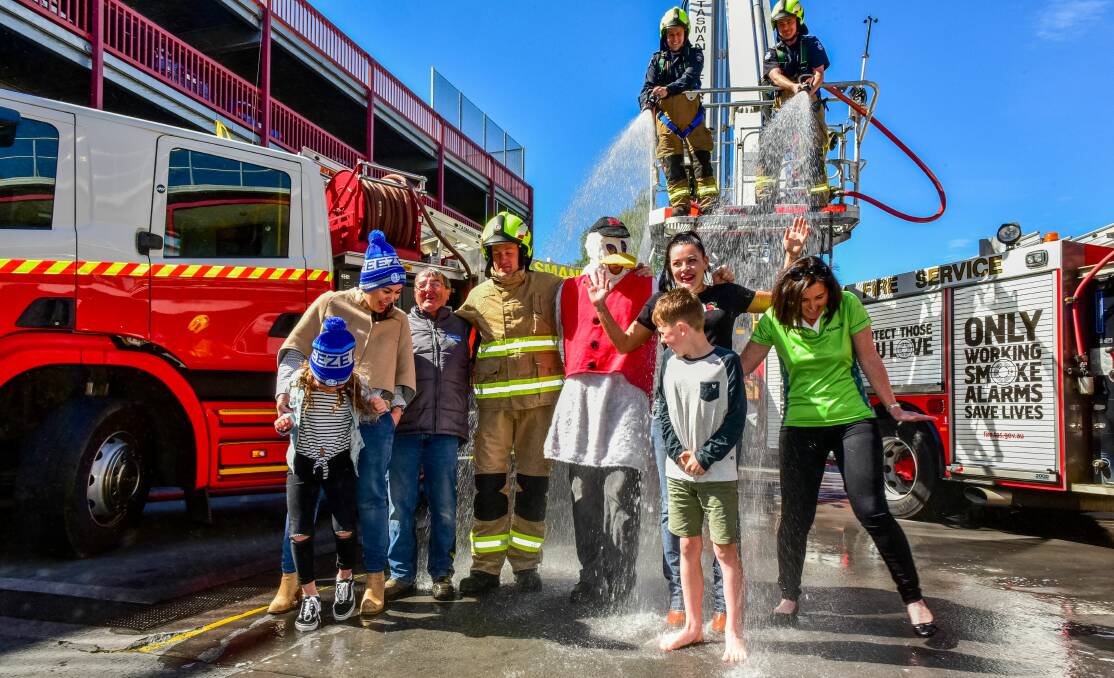 FREEZING FOR A CAUSE: Jelena and Isobel Hill, 7, Paul Spencer, Simon Moore, Dan Taylor, Marie Burt, Rhys Penney, 8, and Kate Dean prepare for the Big Freeze at the Launceston Fire Station. Picture: Neil Richardson.