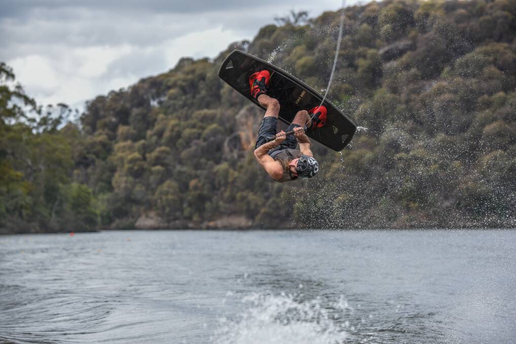 AIRBOURNE: Tasmanian Wakeboarding Association president, and competitor, Nigel Curran wakeboards at Lake Trevallyn. Picture: Paul Scambler