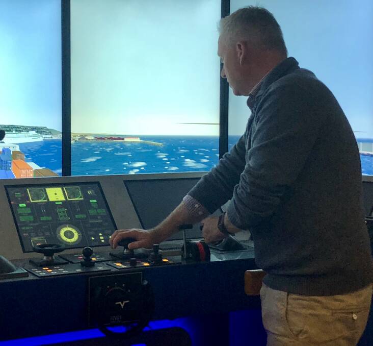Jeremy Rockliff has a go on a simulator at Pivot Maritime.