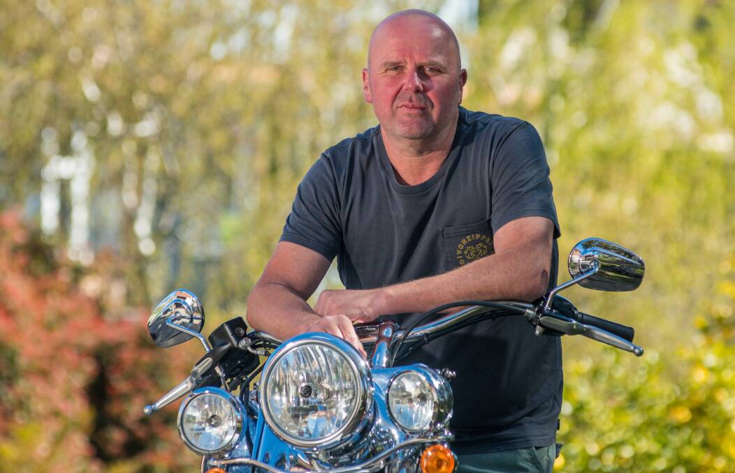 CLOSE CALL: Brett Grey with his pride and joy, a blue and white Harley, which he was riding when hit by a car on Saturday afternoon. Picture: Phillip Biggs
