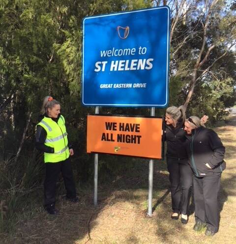 ALL NIGHT LONG: The Break O'Day Council's event coordinator Erica Lowry, community services officer Jenna Bailey, and executive assistant Ange Matthews install signs along the Great Eastern Drive. Picture: supplied