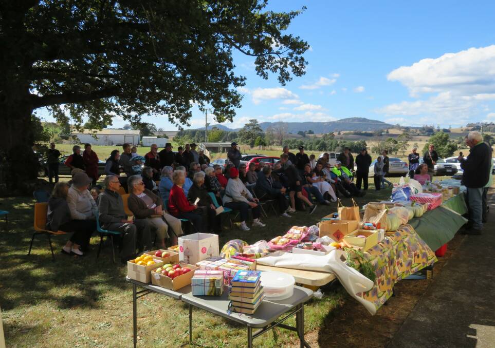 PRODUCE: Crowds at last years event wait to bid on locally grown fruit, vegetables, preserves, and more at the Harvest Festival. Picture: Supplied